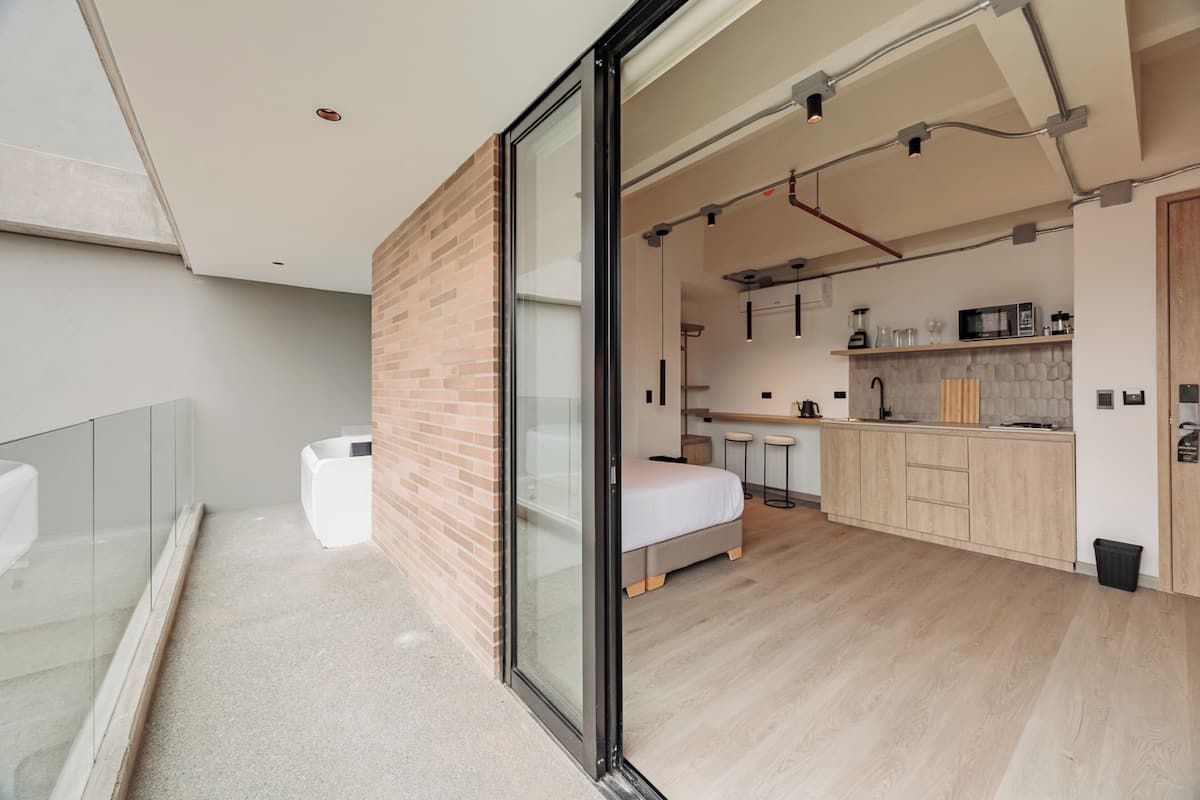 A modern kitchen with a wooden countertop, a built-in oven, and a microwave.