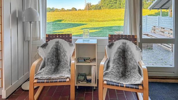 Two chairs with fur upholstery facing a window with a view of a field. - Nice home in Aabenraa with swimming pool (Aabenraa)