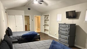 A bedroom with two beds, a dresser, a TV, and a ceiling fan. - Beautiful remodelded 4/1.5 bathroom home in SOUTH CORPUS CHRISTI, close to beach (Corpus Christi)