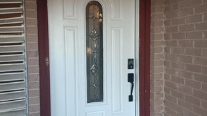 A white door with a glass panel and a keypad lock. - Beautiful remodelded 4/1.5 bathroom home in SOUTH CORPUS CHRISTI, close to beach (Corpus Christi)