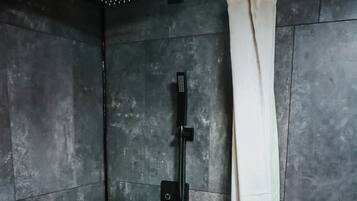 A bathroom with a bathtub, toilet, and shower curtain.