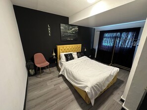 Desk, laptop workspace, blackout drapes, iron/ironing board