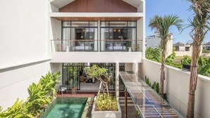 A modern two-story house with a glass balcony, a small pool, and a garden area. - X Samata (Bali)