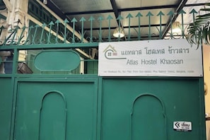 A hostel sign with the name 'Atlas Hostel Khao San' and a green gate with a 'No Entry' sign. - Atlas Hostel Khaosan (Bangkok)