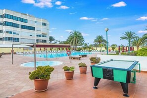 A pool area with a billiards table, lounge chairs, and a building in the background. - Excelsior I Casa LEX Ocean&Sunrise Views Steps to Beach&Dunes Terrace Pool (Playa del Ingles)