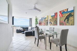 A modern living room with a dining area, large windows, and artwork on the walls. - Excelsior I Casa LEX Ocean&Sunrise Views Steps to Beach&Dunes Terrace Pool (Playa del Ingles)