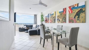 A modern living room with a dining area, large windows, and abstract art on the wall. - Excelsior I Casa LEX Ocean&Sunrise Views Steps to Beach&Dunes Terrace Pool (Playa del Ingles)