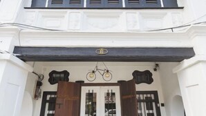 A building facade with a white exterior, black shutters, and a number '37' sign above the entrance. - RumahKu Georgetown (George Town)