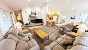 A living room with sofas, a coffee table, a TV, and a fireplace. - Mt Hood 13 - A/C, Hot Tub, 2 Suites, SHARC (Sunriver)