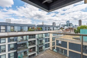 A modern building with multiple floors, large windows, and balconies. - Old Street - Quiet Apartment (London)