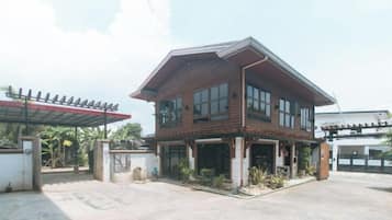A two-story wooden house with a covered porch and a garage.