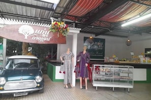 A vintage car parked outside a restaurant with a sign above it. - Keankan Resort (Kanchanaburi)