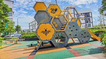 A playground with hexagonal structures and a slide.