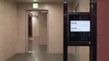 A hallway with a digital keypad for room access.