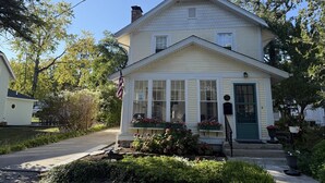 A two-story house with a front porch, a green door, and a mailbox. - 418 E. Third In Lakeside (Lakeside)