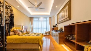 A hotel room with a bed, a ceiling fan, a desk, a chair, and a bookshelf. - Fahrenheit88 - Kuala Lumpur Bukit Bintang Egypt Theme (Kuala Lumpur)