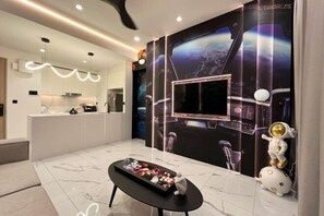 A modern kitchen with a marble countertop, a black dining table, and a wall with a space-themed mural. - Alfa Bangsar by The Homez (Kuala Lumpur)