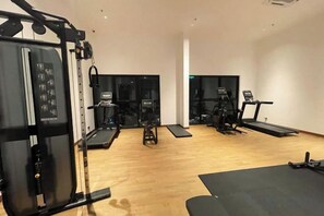 A gym with cardio equipment, weight machines, and a treadmill. - Alfa Bangsar by The Homez (Kuala Lumpur)