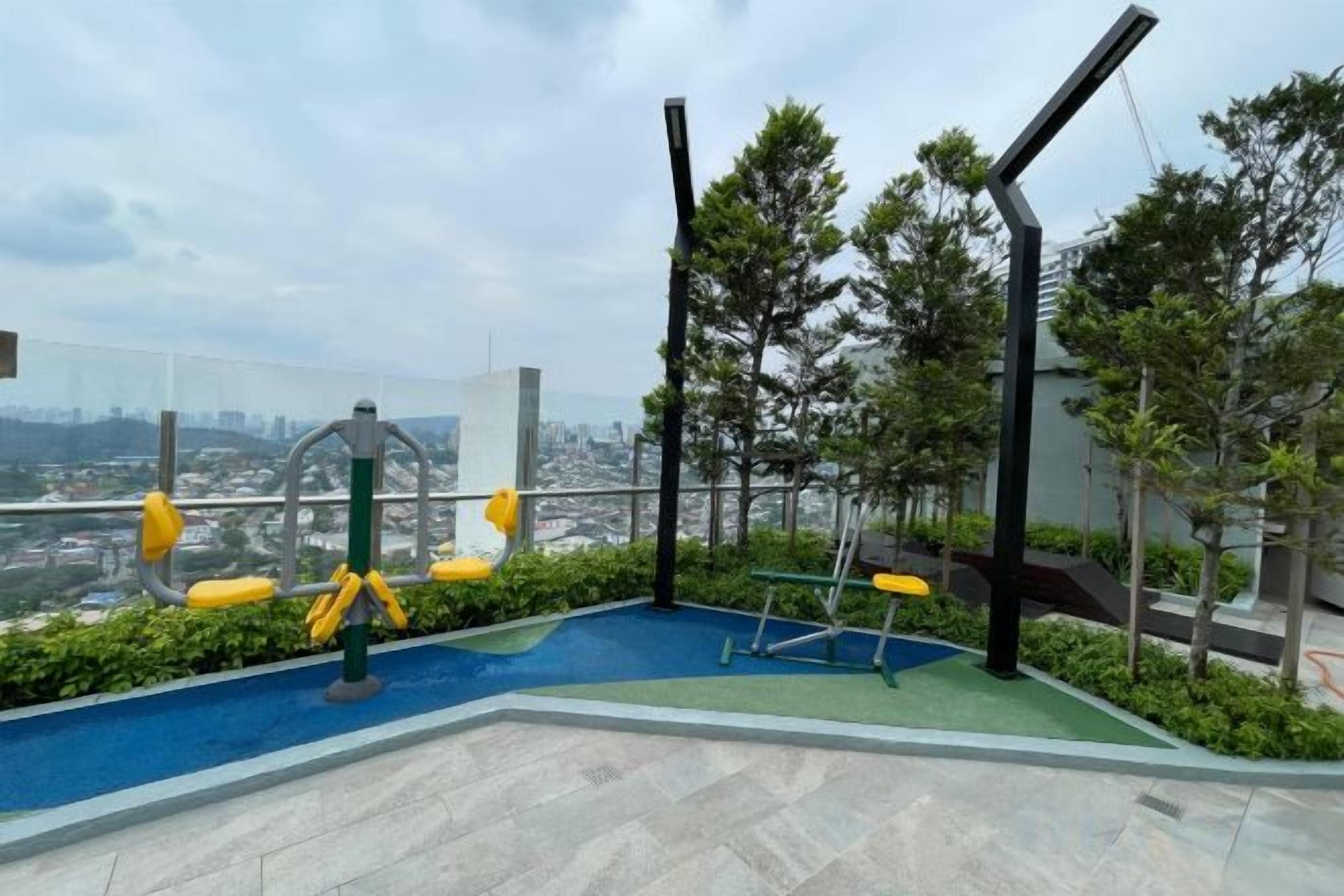 An outdoor exercise area with a view of the city.