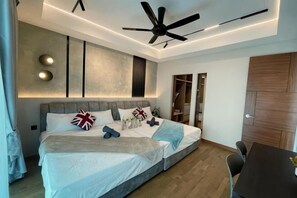 A modern bedroom with a large bed, ceiling fan, and built-in shelving. - Alfa Bangsar by The Homez (Kuala Lumpur)