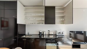 A modern kitchen with a built-in oven, a coffee maker, and a microwave. - Blueground | Basel-Vorstaedte, view, nr Kunstmuseum (Basel)