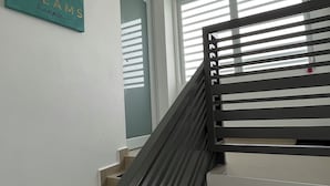 A staircase with a handrail, a sign with the text "DREAMS" and "goals", and a window with blinds. - Villa Carmin 2 with Private Pool (Aguadilla)