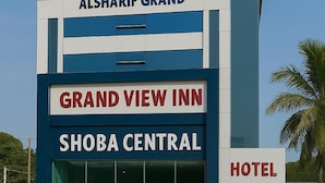 A hotel named Grand View Inn with signage indicating it is part of the Alsharif Grand hotel complex.