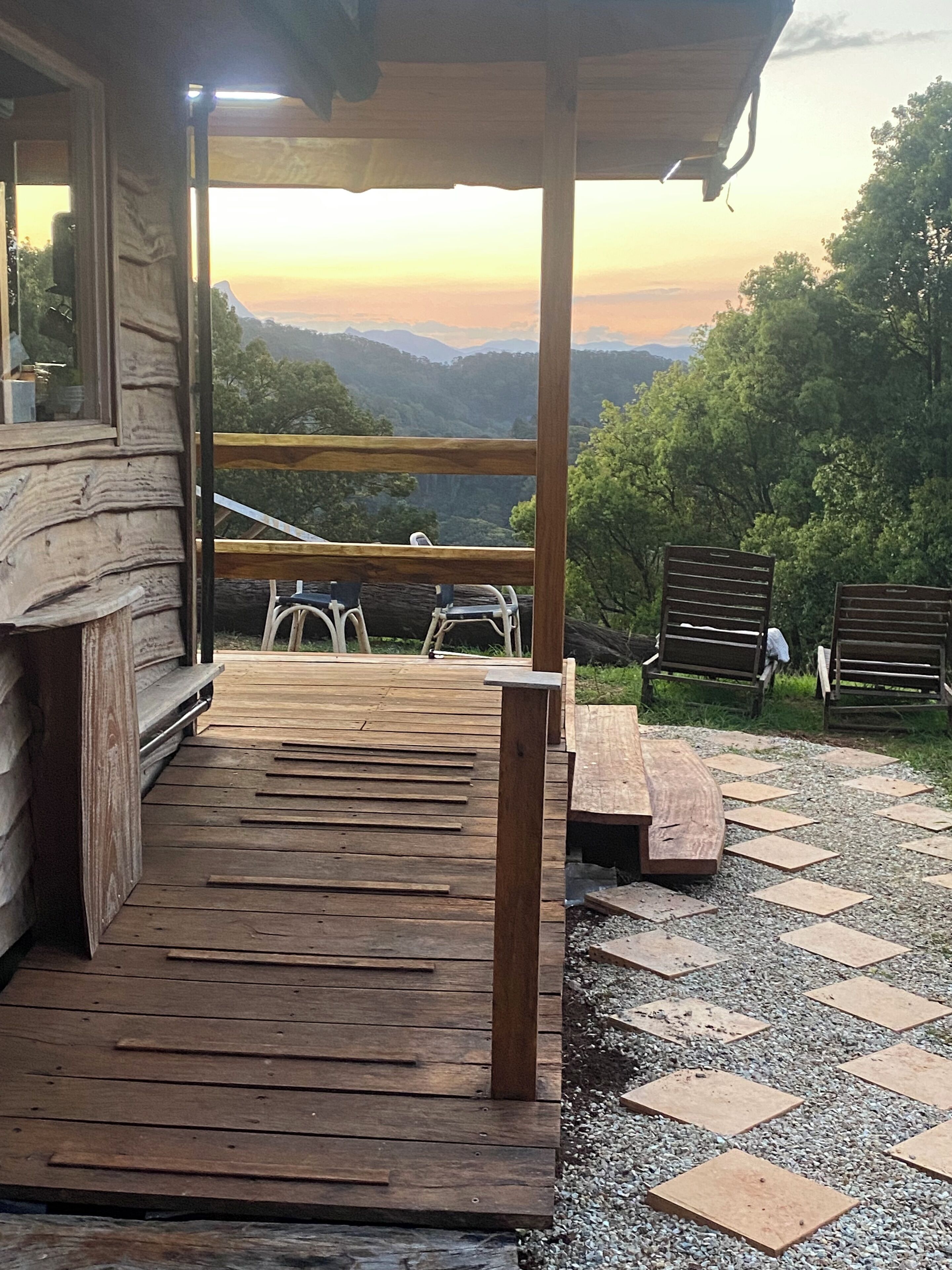 A wooden deck with a view of a mountainous landscape.