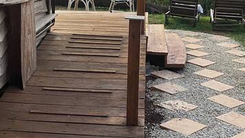 A wooden deck with a view of a mountainous landscape.