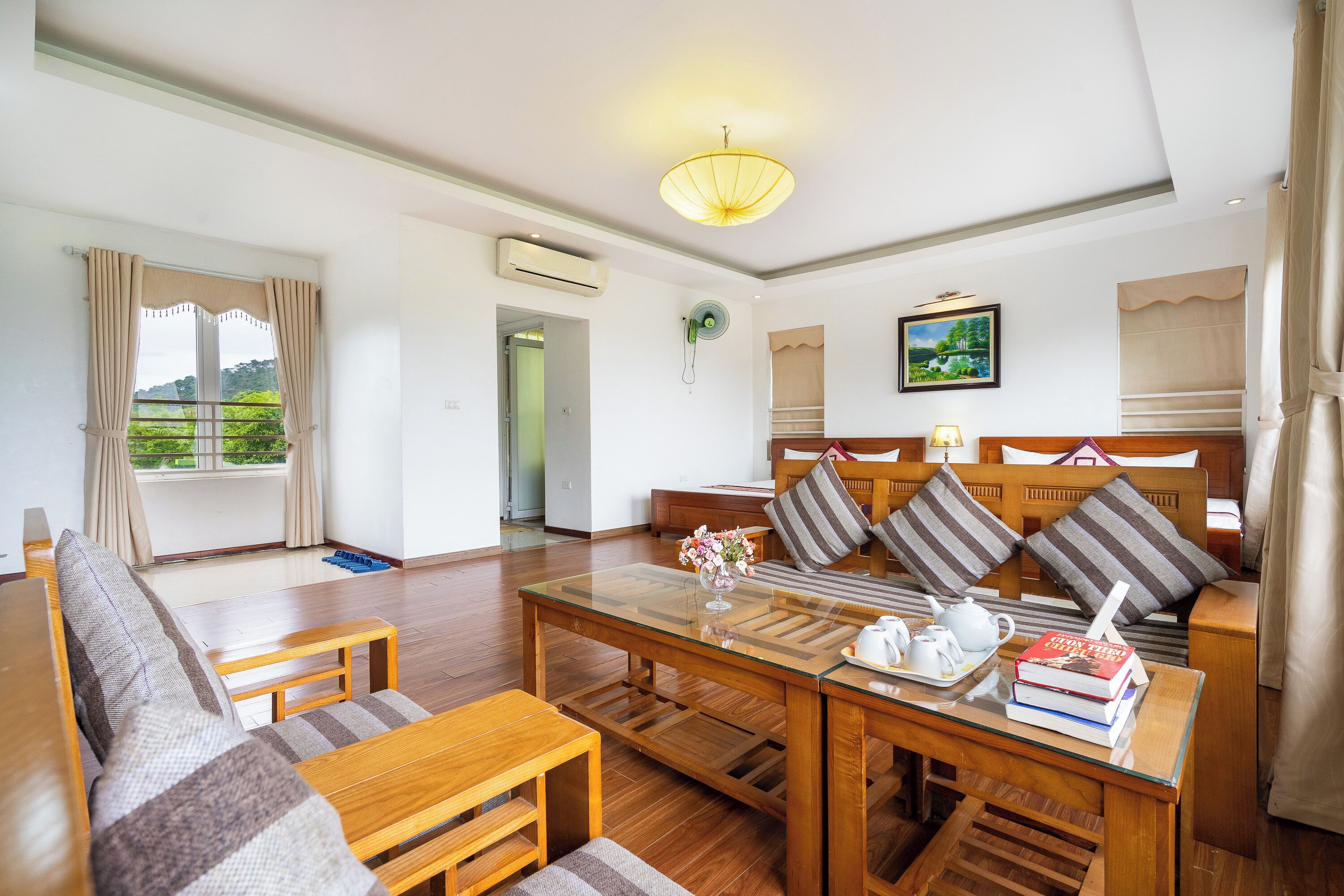 A spacious living area with a sofa, coffee table, and a bookshelf.