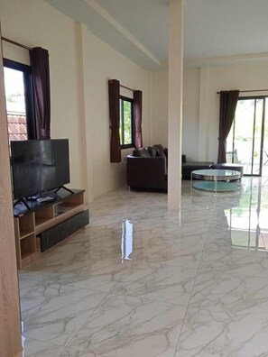 Family Penthouse, Mountain View | Living area | 18-inch LED TV with satellite channels - M&N Guesthouse Kata (Karon)