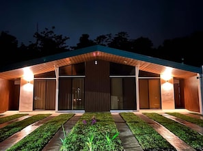 Un edificio moderno con techo plano, ventanas amplias y una entrada bien iluminada.