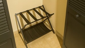 A small, enclosed room with a metal drying rack and a door with a handle.