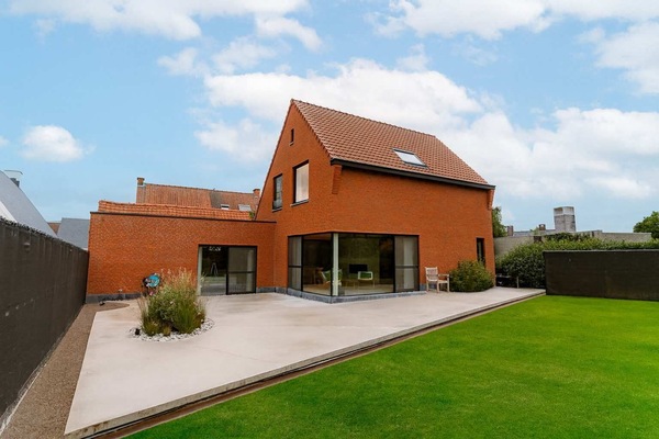 Red brick home exterior with spacious garden for garden fun.