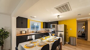 A modern kitchen with a dining area set for a meal.