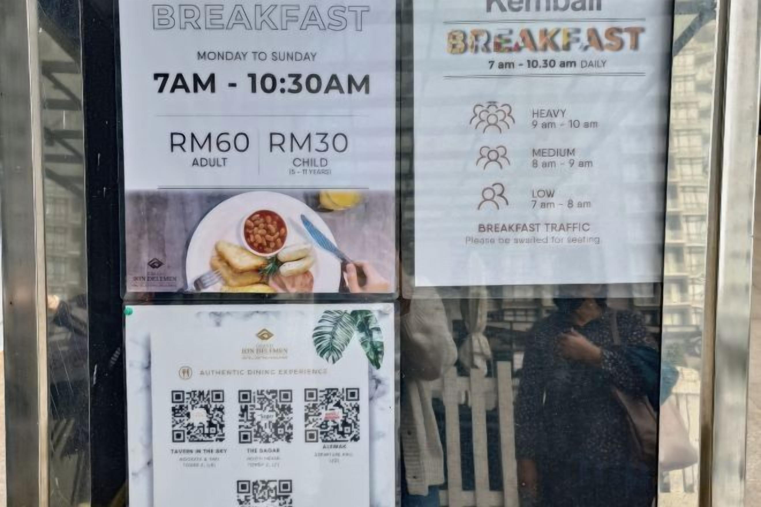 A breakfast menu board with prices and time slots for adults and children.