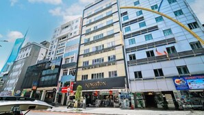 A multi-story hotel with a modern facade, a prominent sign for the Kingston Hotel, and various storefronts on the ground floor. - Kingston Hotel 1 @ Bukit Bintang (Kuala Lumpur)