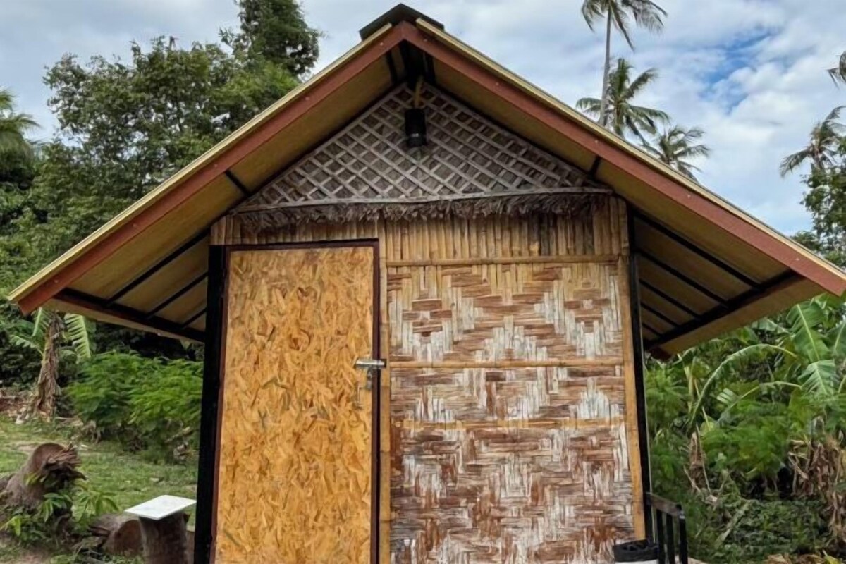 A small, single-room structure with a sloped roof and a wooden door.