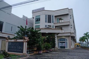 Un hotel con fachada moderna, una entrada destacada y un letrero que indica que es un hotel.