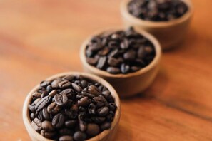 Three wooden bowls filled with coffee beans. - Lemon Tree Hotel Bali (Bali)