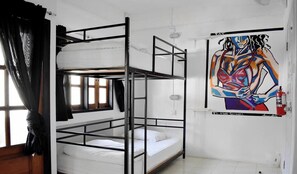 A bunk bed room with a window, a painting on the wall, and a fire extinguisher. - Bodega Soi 23 Bangkok (Bangkok)