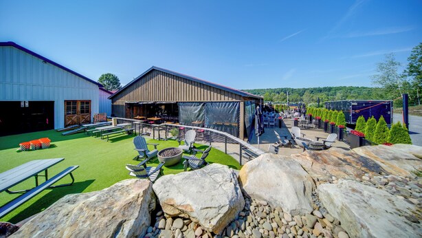 A patio area with outdoor seating, a barbecue grill, and a covered seating area. - ‘Choo Choo Blue,’ Converted Railcar in DuBois! (DuBois)
