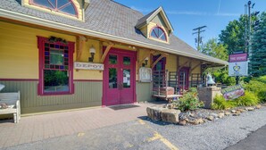 A building with a red door, a sign reading "The Depot," and a sign for "The Depot Restaurant." - 'Red NY Central,' Converted Railcar in DuBois! (DuBois)