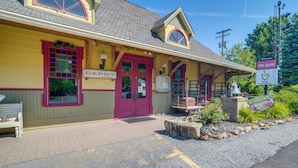 A building with a red door, a sign reading "The Depot," and a sign for "The Depot Restaurant."