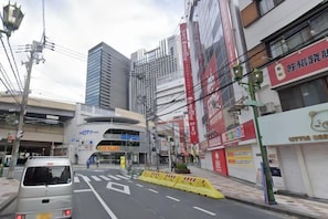 A street view with a building that has a sign for 'City' and a pedestrian crossing. - Asobo osaka nipponbashi Apartment (Osaka)