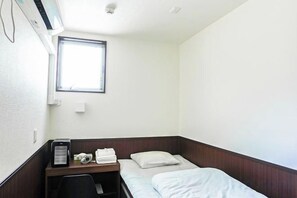 A small, single-bed room with a desk, a chair, and a window. - SAMURAI STAY Senzoku Pond【MALE ONLY】 (Tokyo)