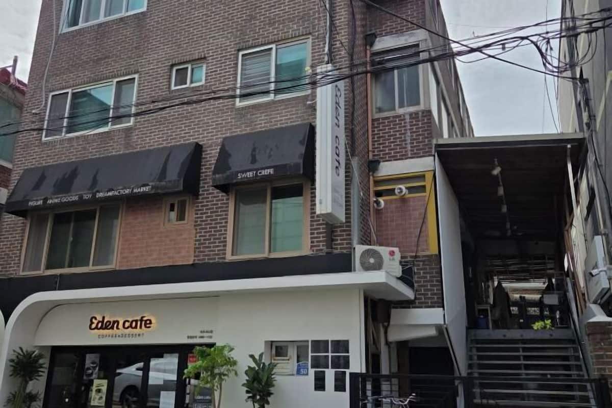 A multi-story building with a coffee shop named Eden Cafe at the ground level.