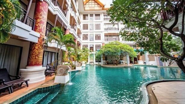 A hotel with a swimming pool, multiple balconies, and lush greenery. - Lanna Hotel by Kasalong Resort and Spa Pattaya (Pattaya)