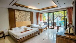 A hotel room with two beds, a large window, a pool view, and a reception area. - Lanna Hotel by Kasalong Resort and Spa Pattaya (Pattaya)