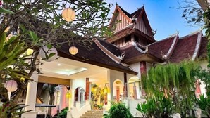 A traditional building with a covered entrance, steps leading up to a porch, and potted plants around the area. - Lanna Hotel by Kasalong Resort and Spa Pattaya (Pattaya)